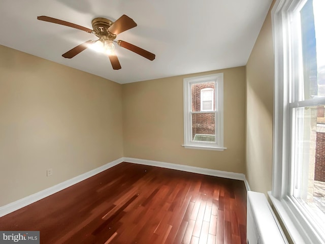 empty room featuring dark hardwood / wood-style floors and ceiling fan