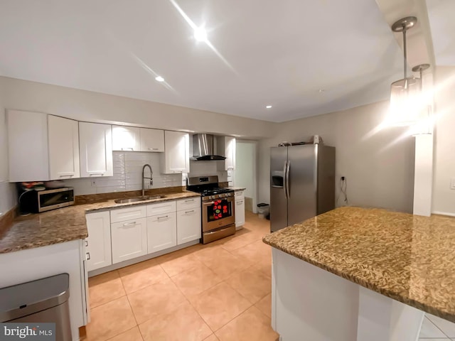 kitchen with white cabinetry, sink, stainless steel appliances, wall chimney range hood, and light stone counters