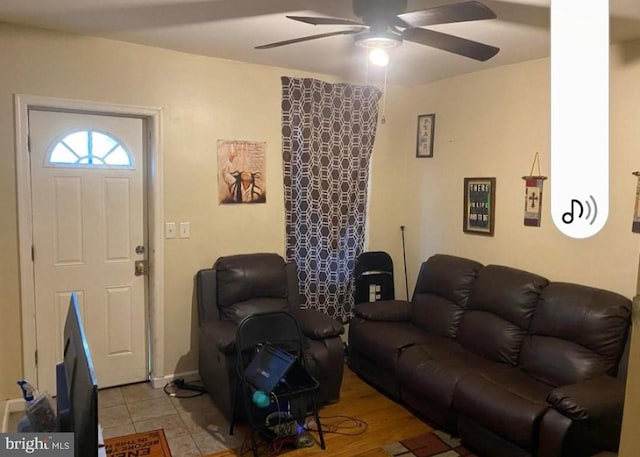 tiled living room featuring ceiling fan