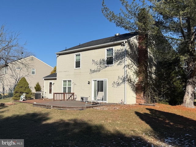 rear view of house featuring a yard, a wooden deck, and central air condition unit