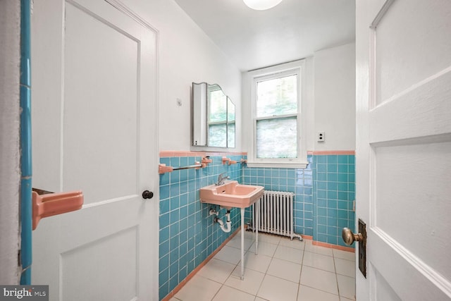 bathroom featuring tile walls, tile patterned flooring, and radiator heating unit