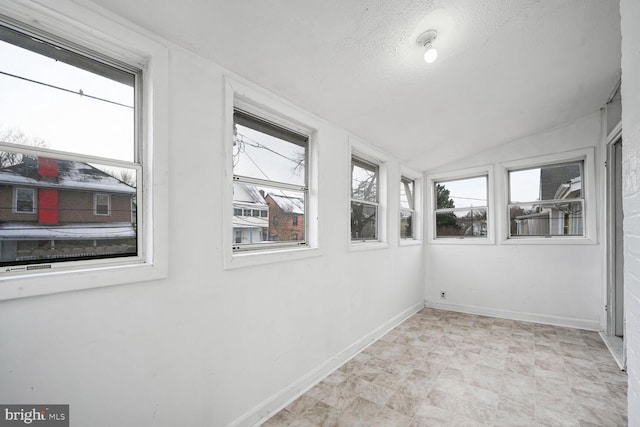 unfurnished sunroom featuring lofted ceiling