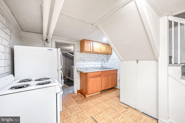 kitchen featuring white appliances, light parquet flooring, and sink