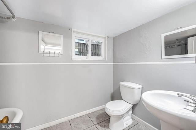 bathroom with sink, tile patterned floors, and toilet