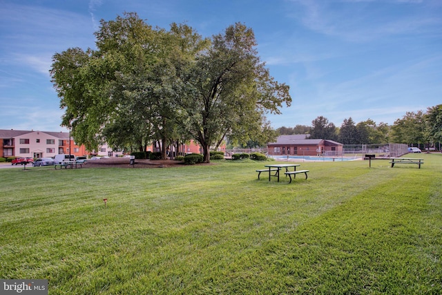 view of property's community with a lawn