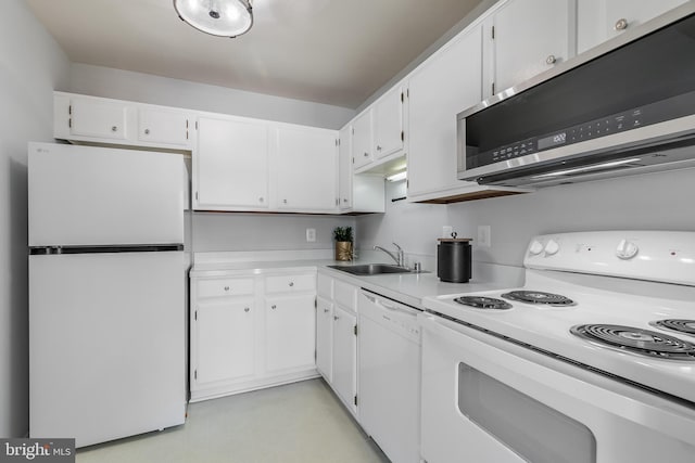 kitchen with sink, white appliances, and white cabinets