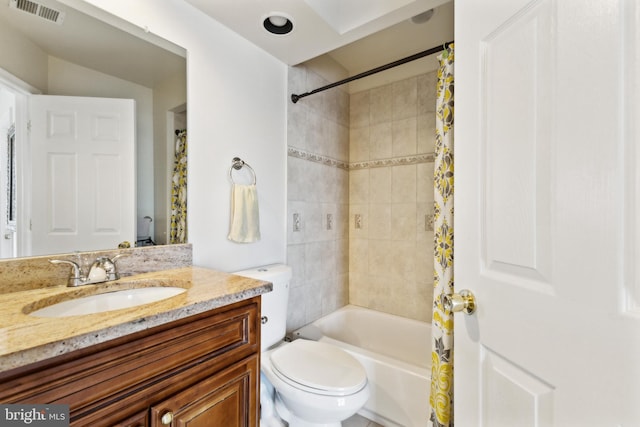 full bathroom featuring toilet, shower / bath combination with curtain, and vanity