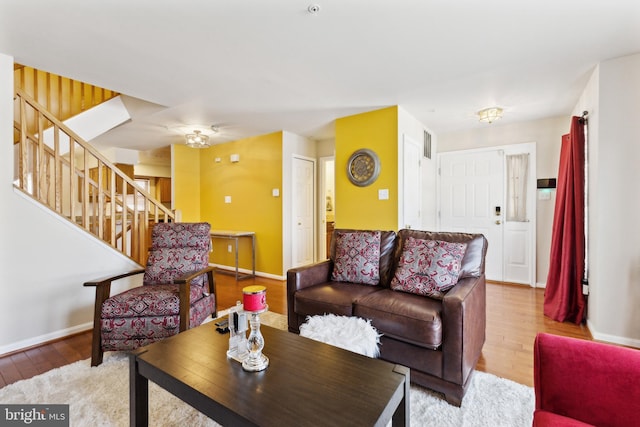 living room featuring ceiling fan and light hardwood / wood-style floors