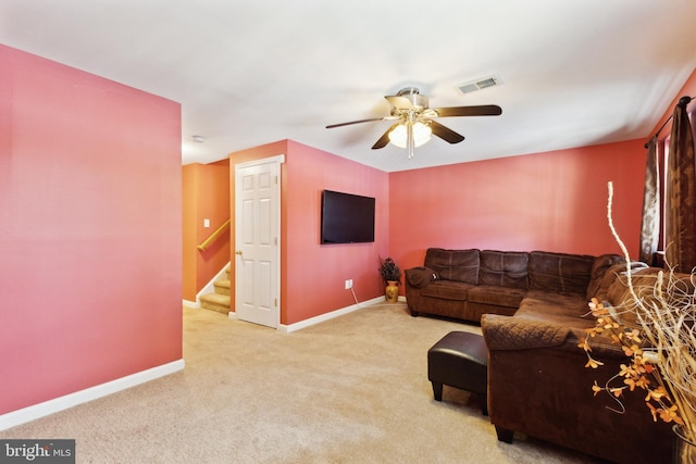 living room featuring ceiling fan and light colored carpet