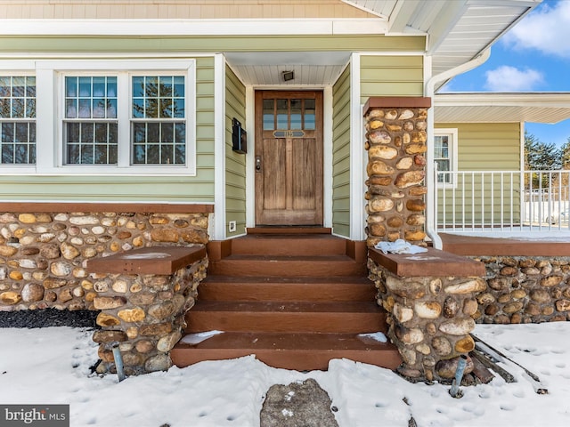 view of snow covered property entrance