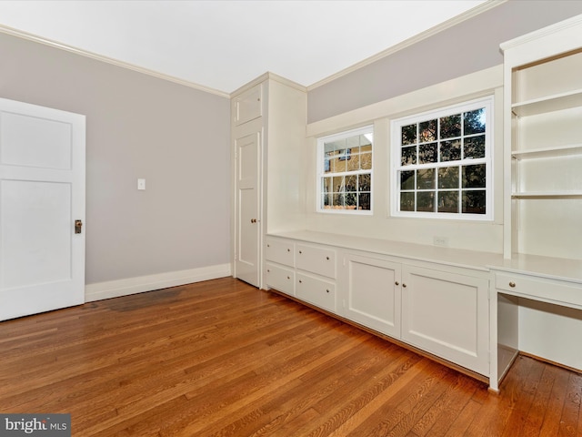 interior space with ornamental molding and light hardwood / wood-style floors