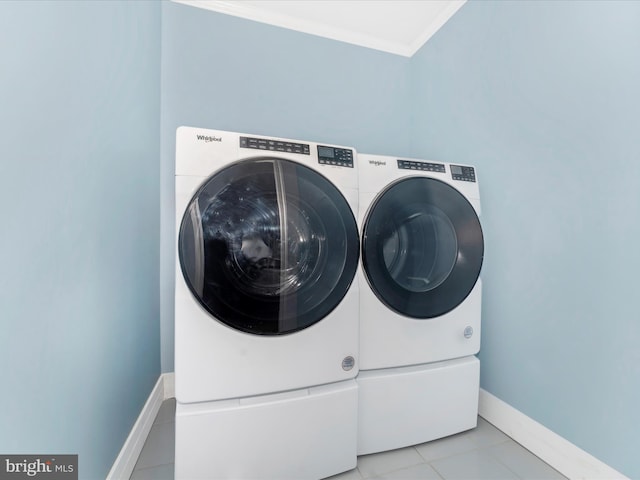 washroom featuring washing machine and dryer and light tile patterned flooring