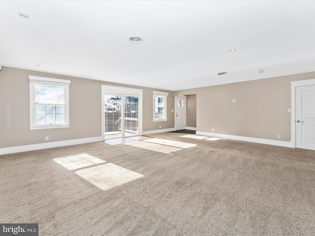 unfurnished living room with light colored carpet