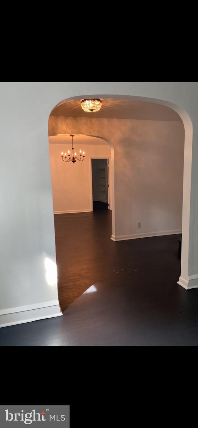 hallway featuring a notable chandelier