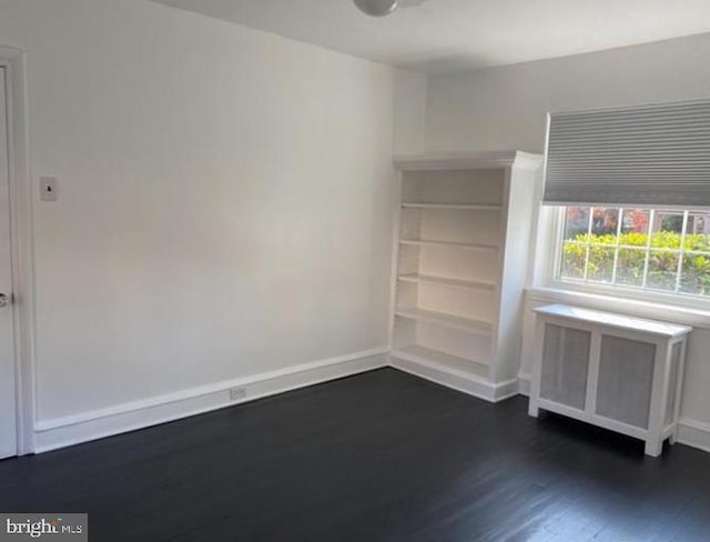 unfurnished room featuring dark hardwood / wood-style flooring