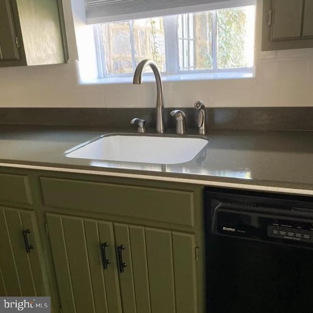 details featuring sink, green cabinetry, and black dishwasher