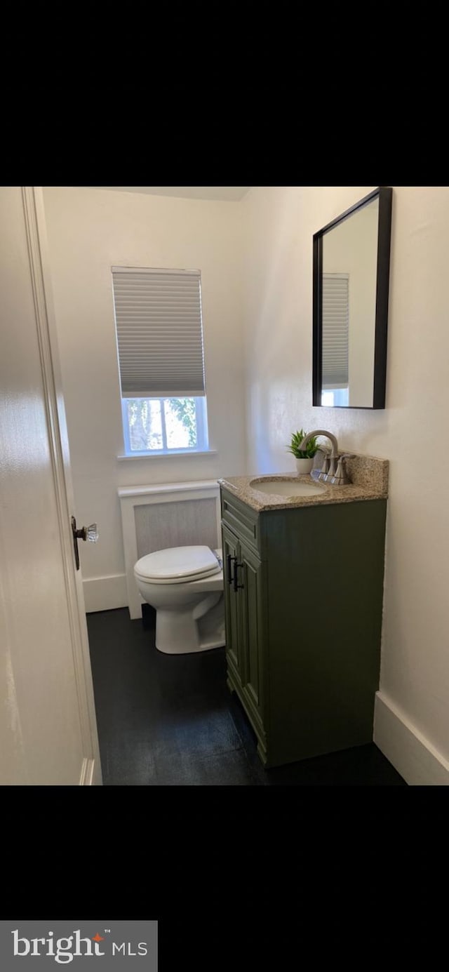 bathroom featuring vanity and toilet