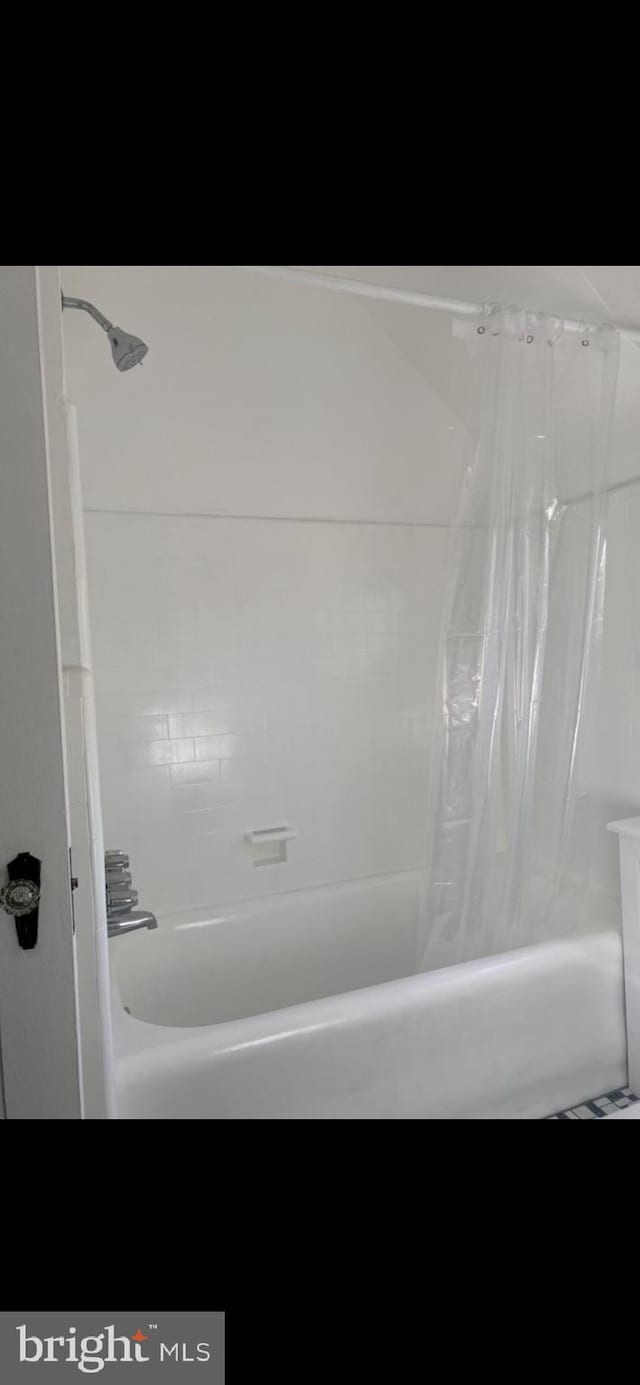 bathroom with shower / bath combination with curtain