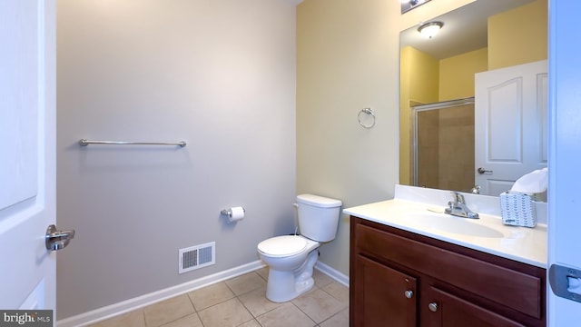 bathroom with toilet, tile patterned flooring, a shower with shower door, and vanity