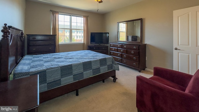 bedroom with ceiling fan and light carpet