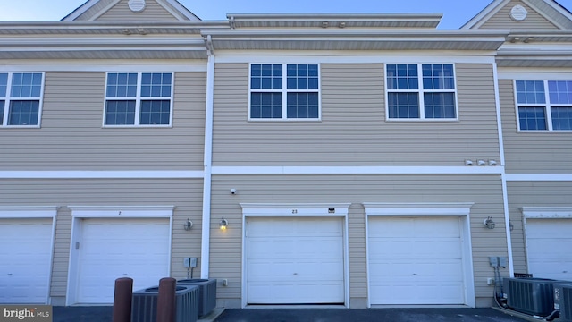 exterior space featuring cooling unit and a garage