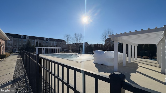 view of patio with grilling area, a covered pool, and a pergola