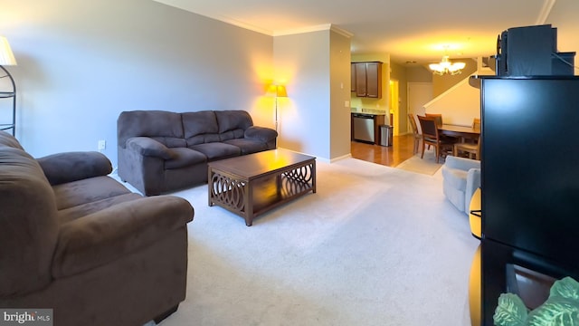 living room featuring a notable chandelier, ornamental molding, and light carpet