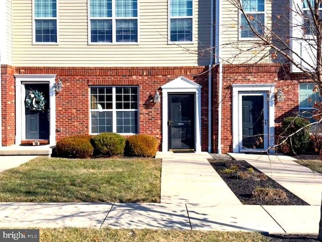 doorway to property with a lawn