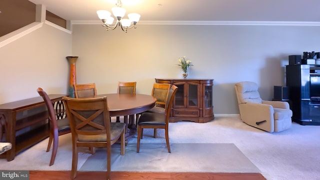 dining space featuring carpet floors, crown molding, and a notable chandelier