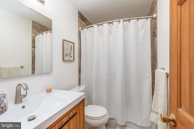 bathroom featuring a shower with curtain, toilet, and vanity