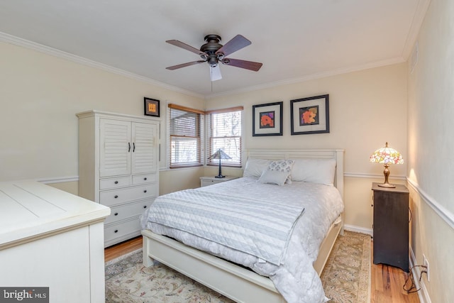 bedroom with ceiling fan, light hardwood / wood-style flooring, and ornamental molding