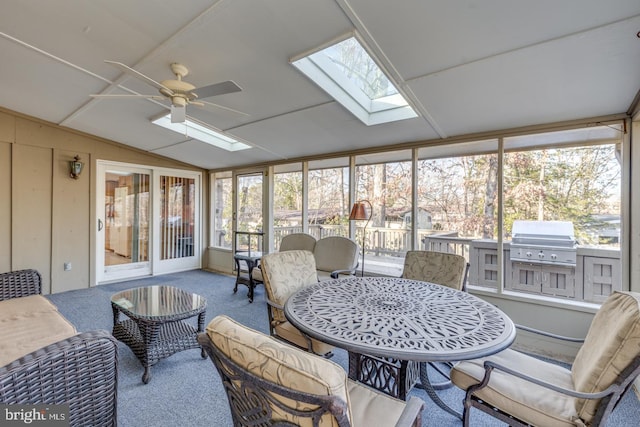 sunroom with ceiling fan, a healthy amount of sunlight, and lofted ceiling