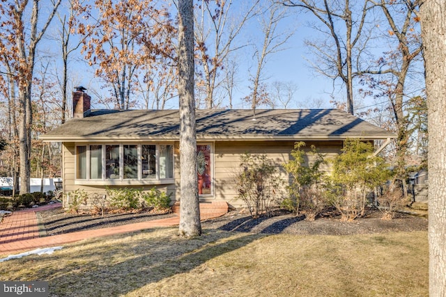 ranch-style home with a front lawn