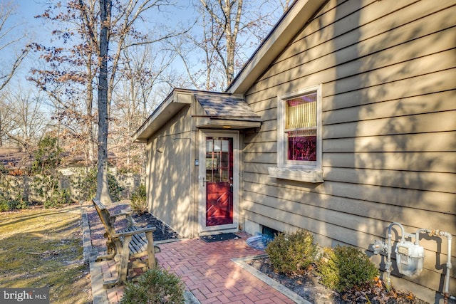 view of exterior entry featuring a patio