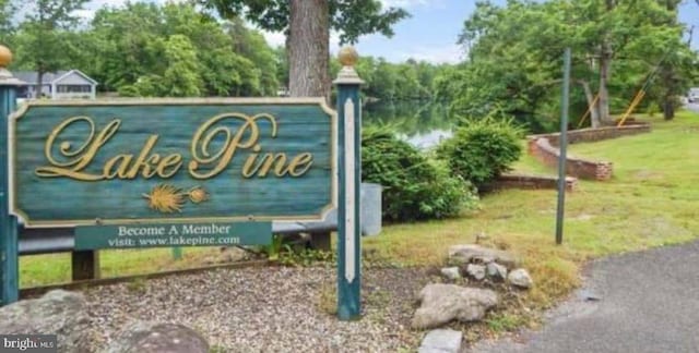 community sign with a water view