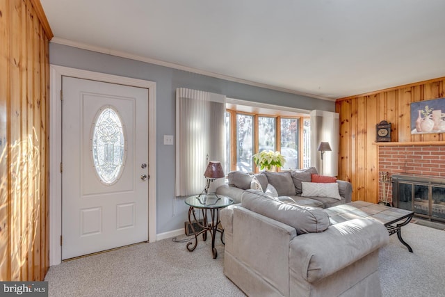 living room featuring a fireplace, wooden walls, crown molding, and light carpet