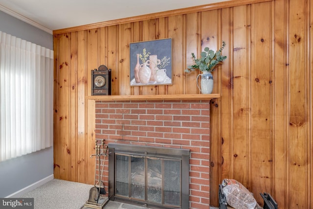 interior details with carpet, a brick fireplace, crown molding, and wooden walls