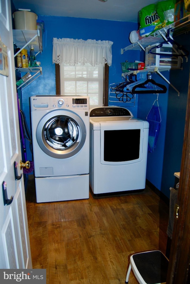 laundry room with dark hardwood / wood-style flooring and washer and clothes dryer