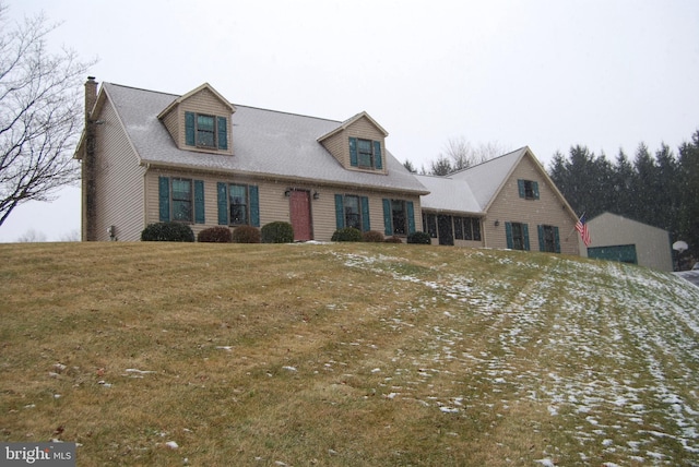 cape cod home with a front yard