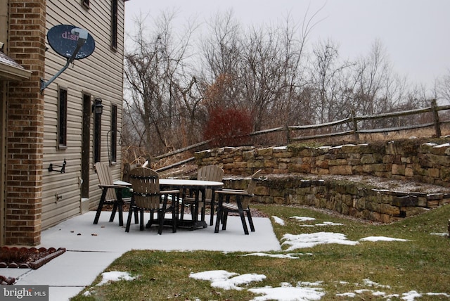 snowy yard with a patio area