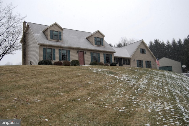 cape cod house with a front lawn