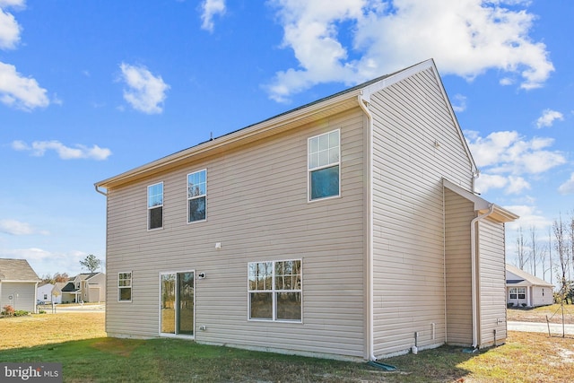 rear view of property with a yard