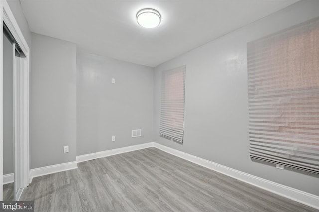 unfurnished bedroom featuring light hardwood / wood-style floors and a closet