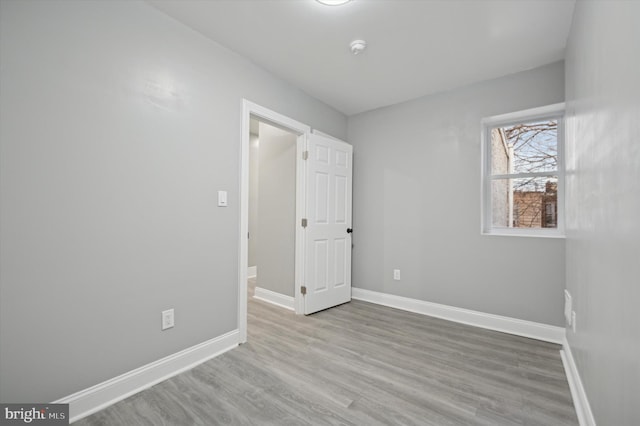 spare room with wood-type flooring