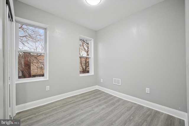 empty room with hardwood / wood-style flooring