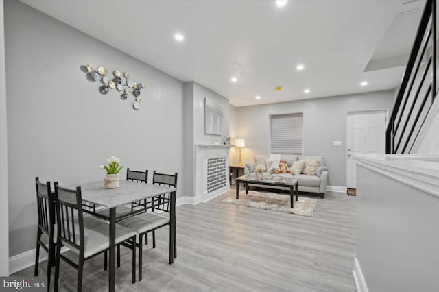 dining space with light hardwood / wood-style flooring