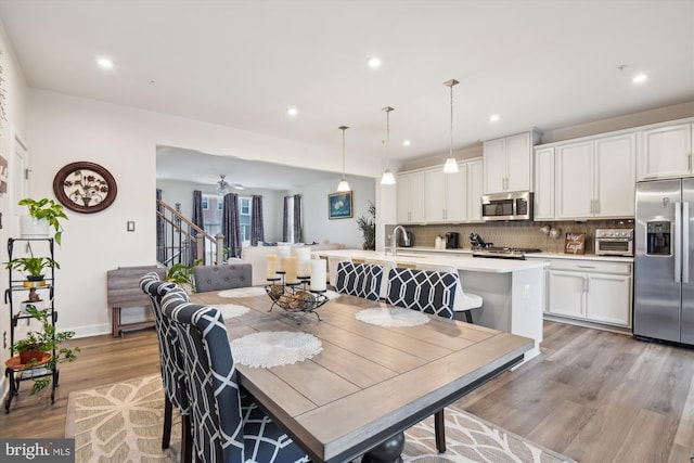 dining area featuring light hardwood / wood-style floors and ceiling fan