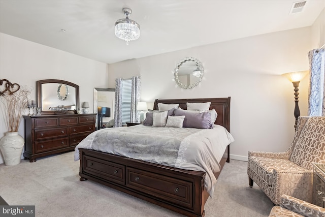 carpeted bedroom featuring a notable chandelier