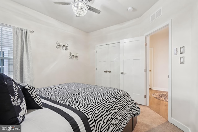 bedroom with light carpet, a closet, and ceiling fan