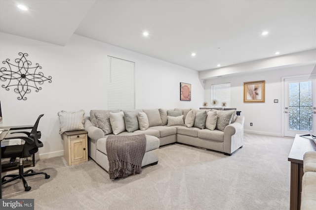 carpeted living room featuring plenty of natural light